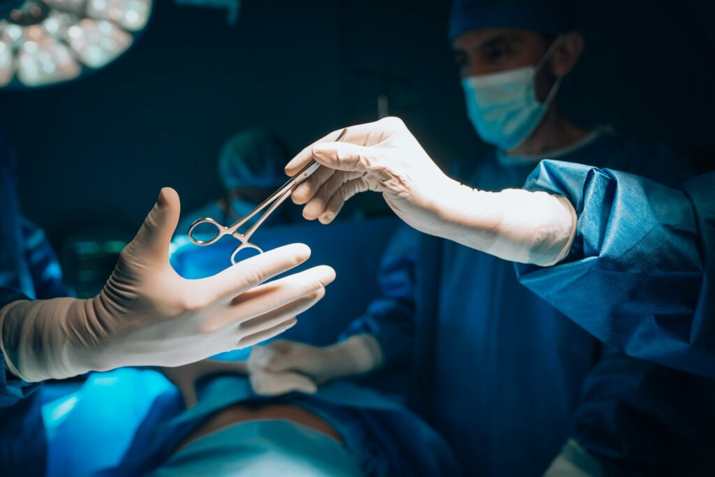 Surgical team passing instruments during an operation
