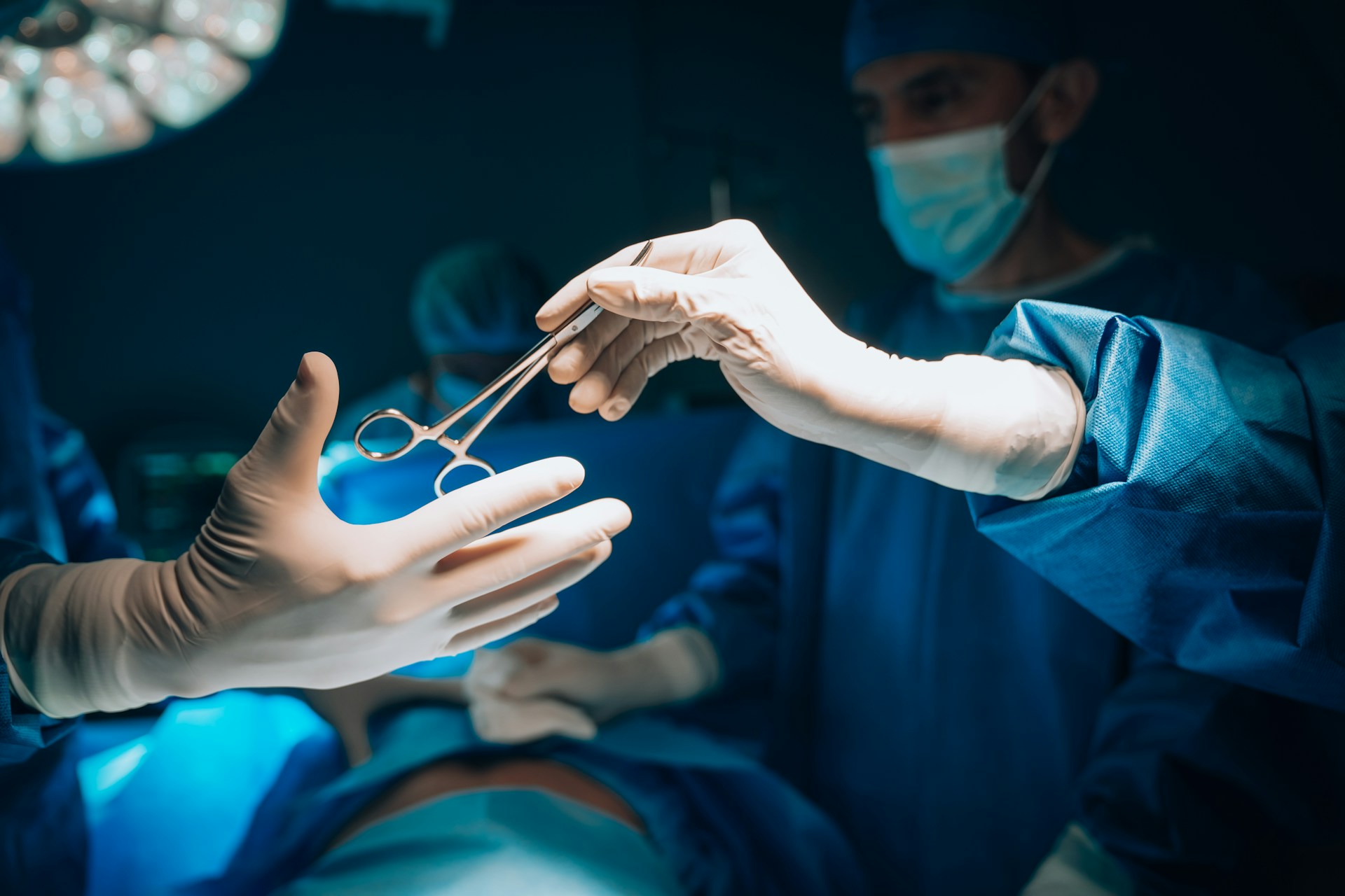 Surgical team passing instruments during an operation